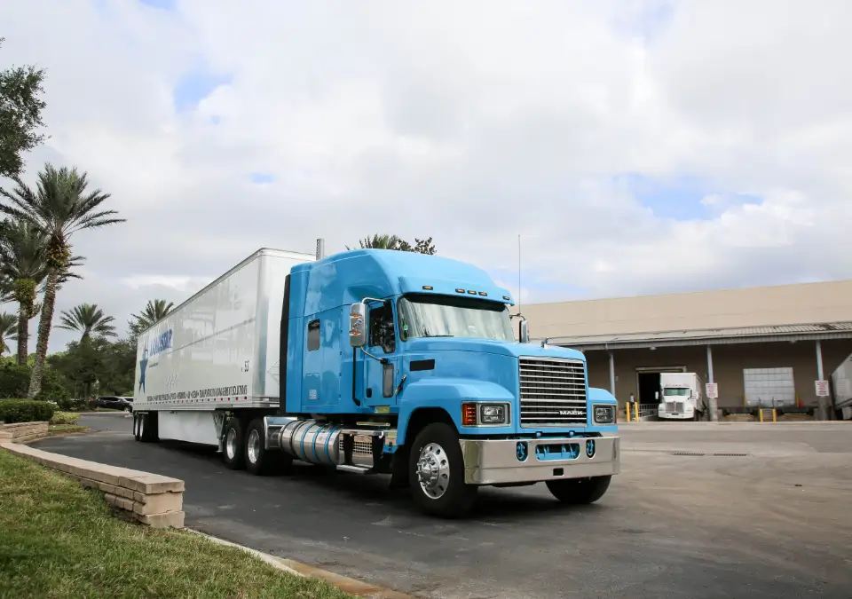 A large semi truck waiting at a loading bay. 